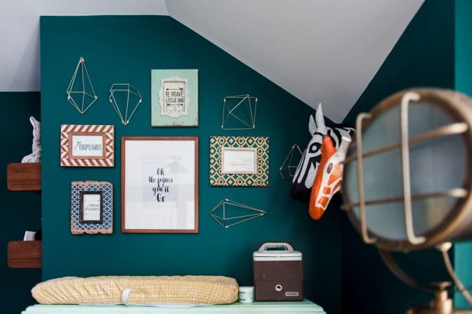 newborn nursery with framed photos and geometric shapes