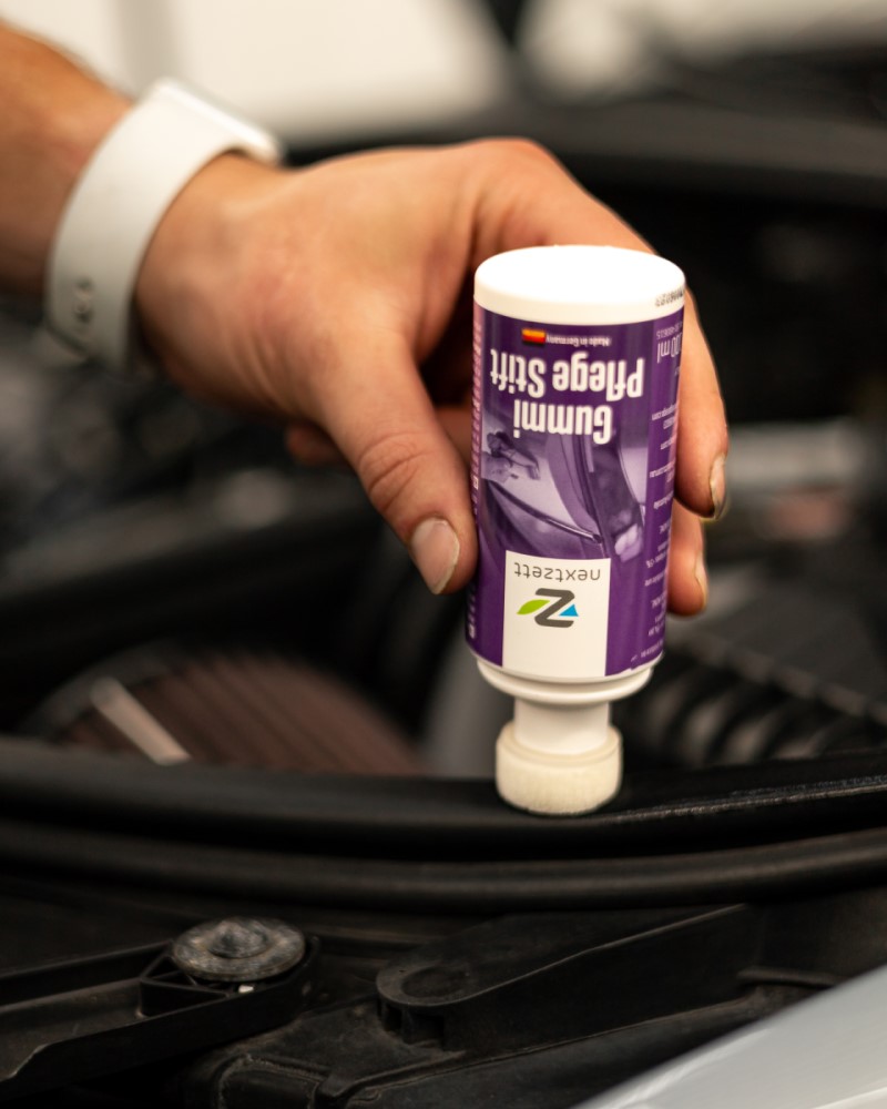 Applying Gummi Pflege weather seal conditioner on car weather seals