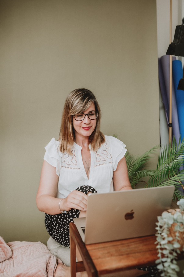 Claire Venus - UK Substack consultant at her laptop writing a substack post.
