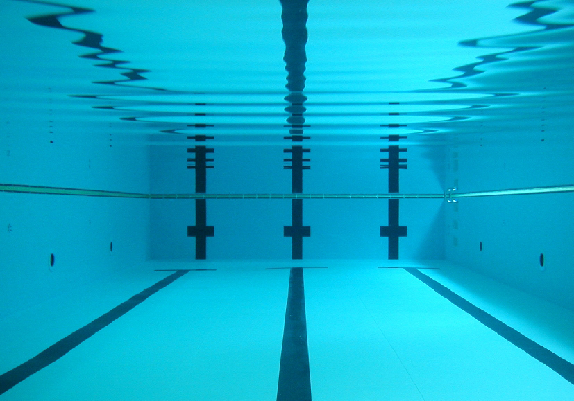 An underwater photo of a pool with crystal clear water