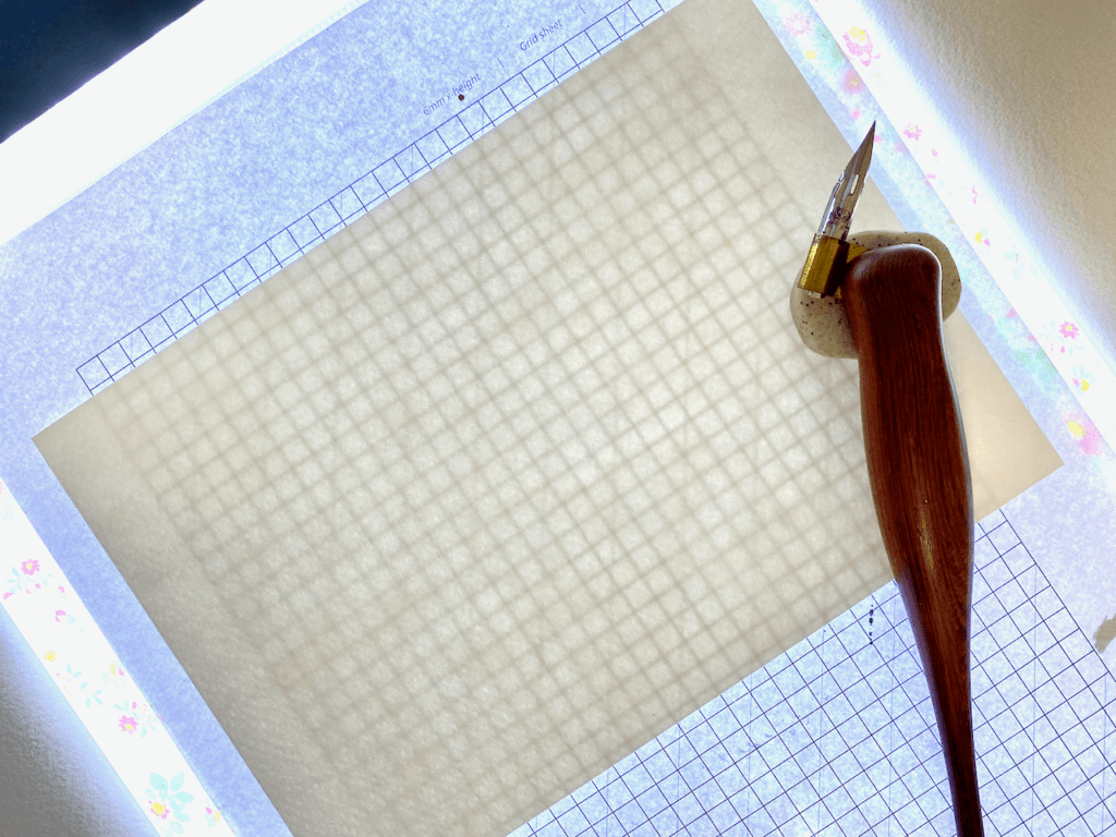 Using a light pad with calligraphy guidelines
