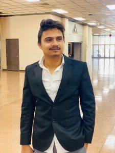 Kaushik Adhikari standing in a hallway.