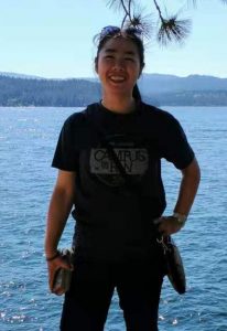 Yang Hu standing in front of water.