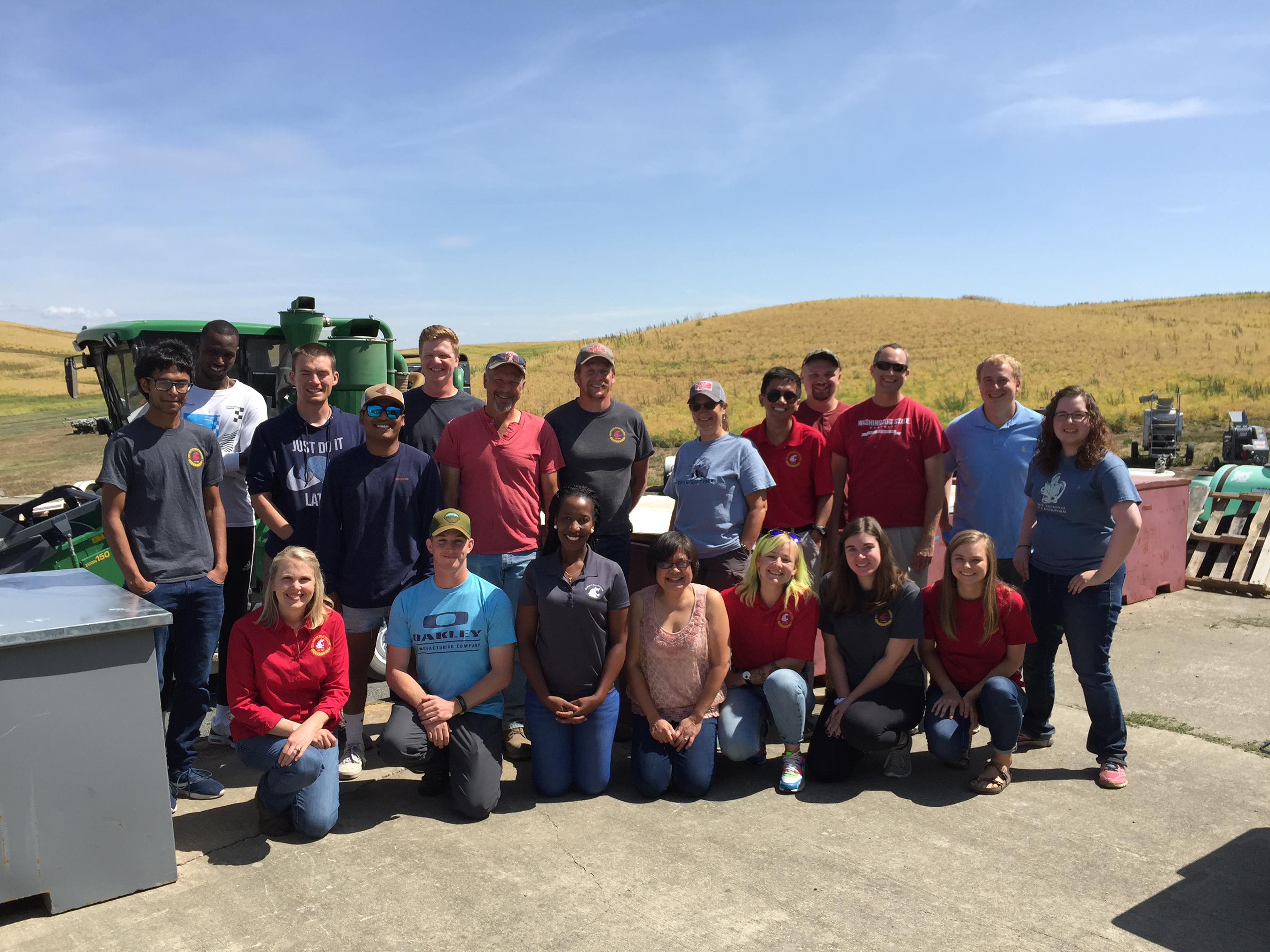 Group standing in front of a combine.