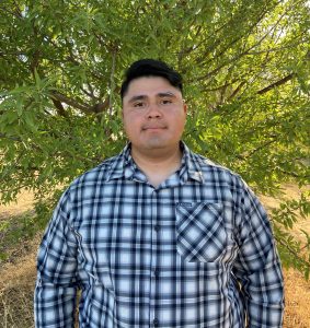 Paul Martinez standing in front of a tree.