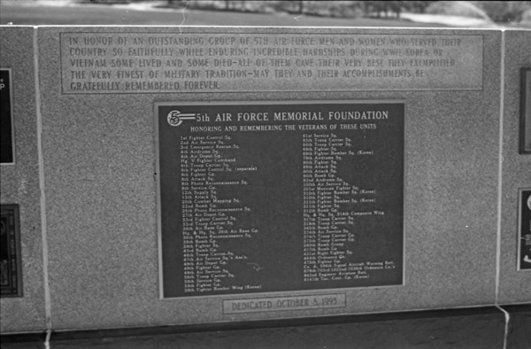 A close-up of a memorial plaque with two long lists of military units being memorialized. Many are not readable due to low resolution.