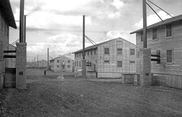 A series of two-story buildings or barracks, lined up with one another.