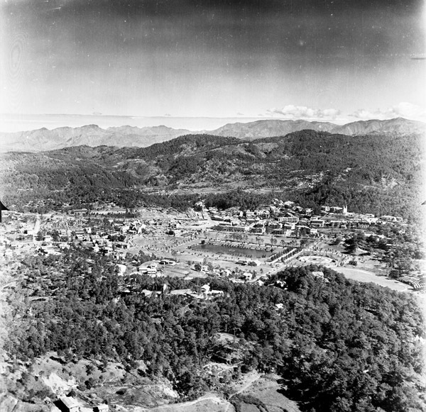 A small city surrounded by low hills.