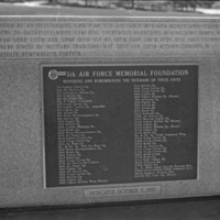 A close-up of a memorial plaque with two long lists of military units being memorialized. Many are not readable due to low resolution.