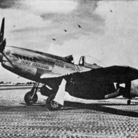 A F-6D P-51 Mustang airplane sitting still on the ground.