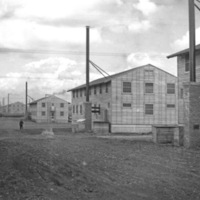 A series of two-story buildings or barracks, lined up with one another.