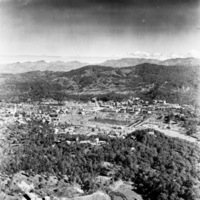 A small city surrounded by low hills.