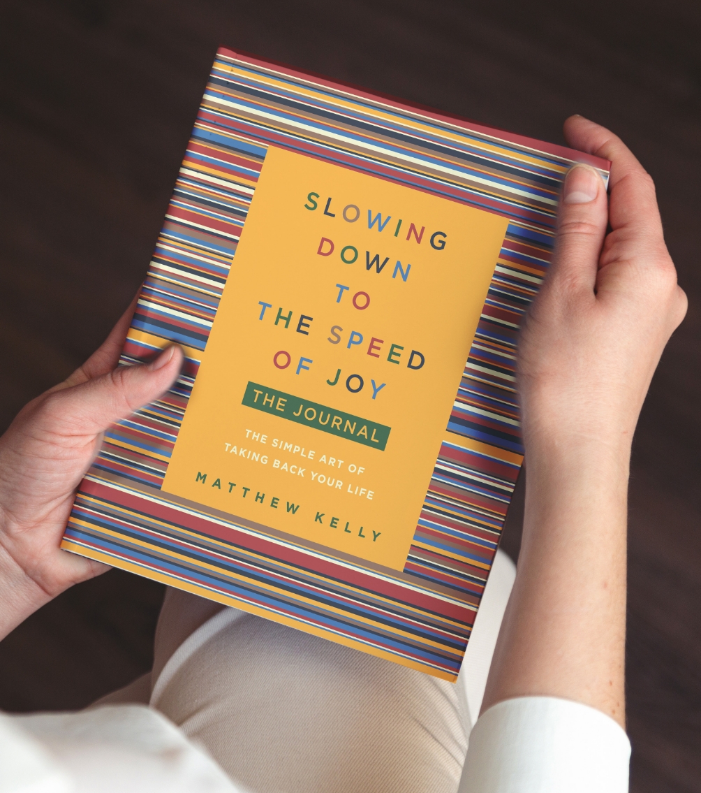 Photo of a woman holding Slowing Down to the Speed of Joy: The Journal