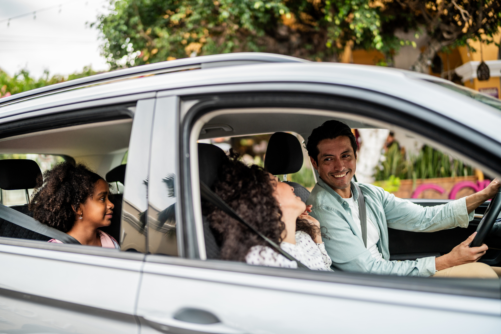 person with friends happy in car