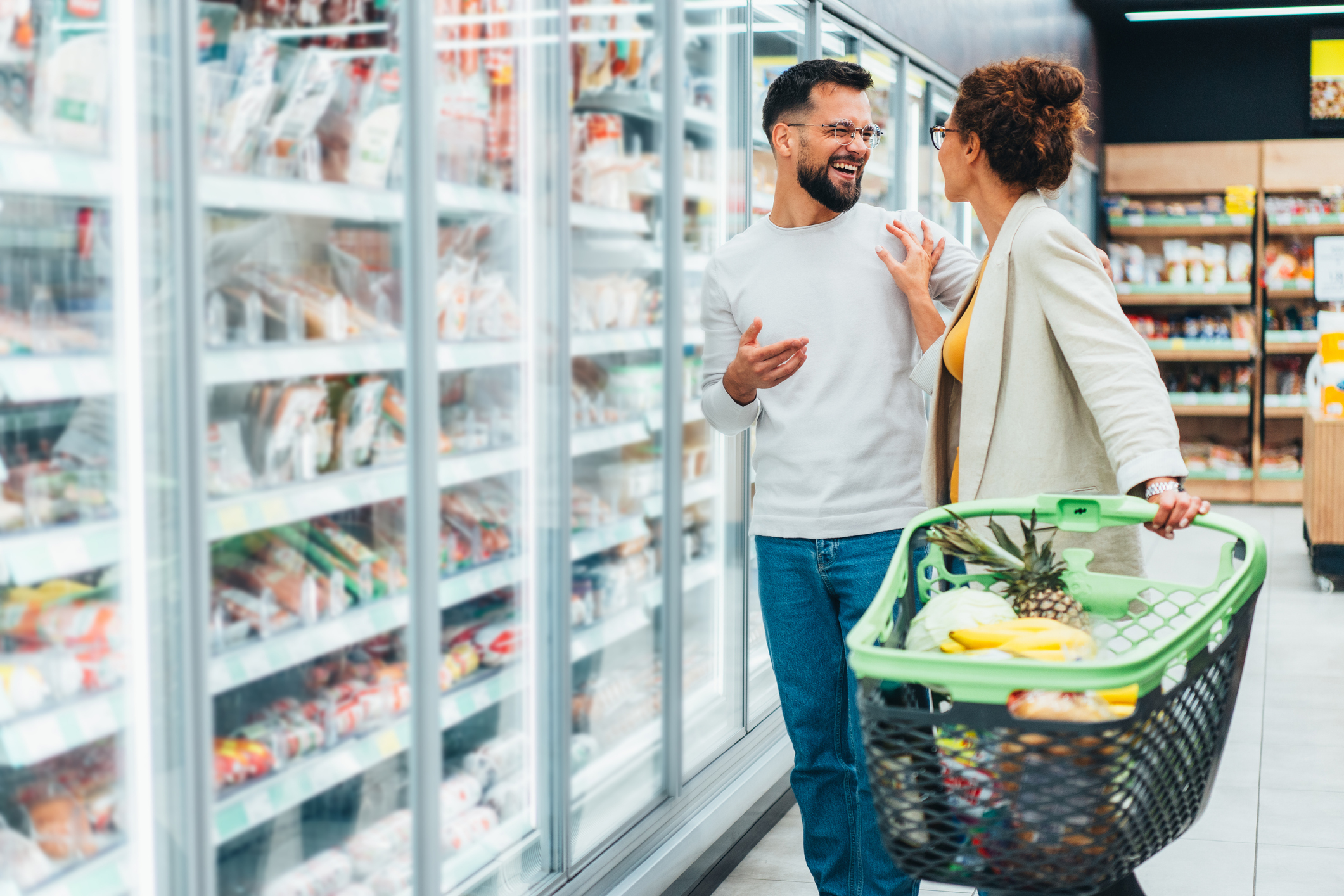 happy couple grocery shopping
