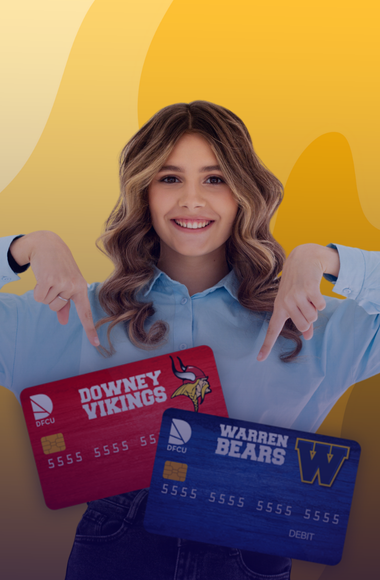 happy teen holding debit cards