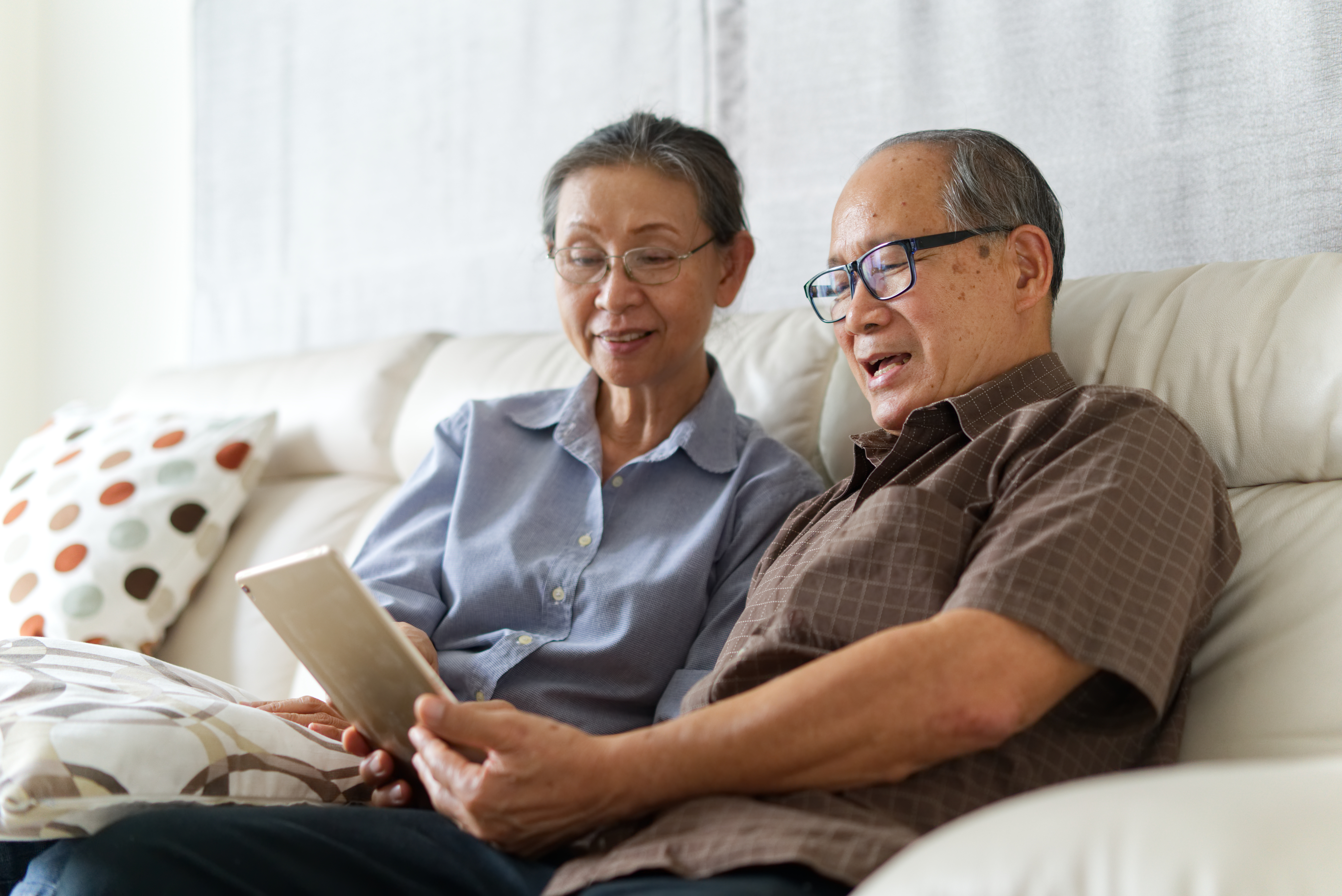 couple looking at tablet happy