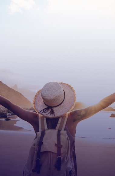 person feeling free at beach