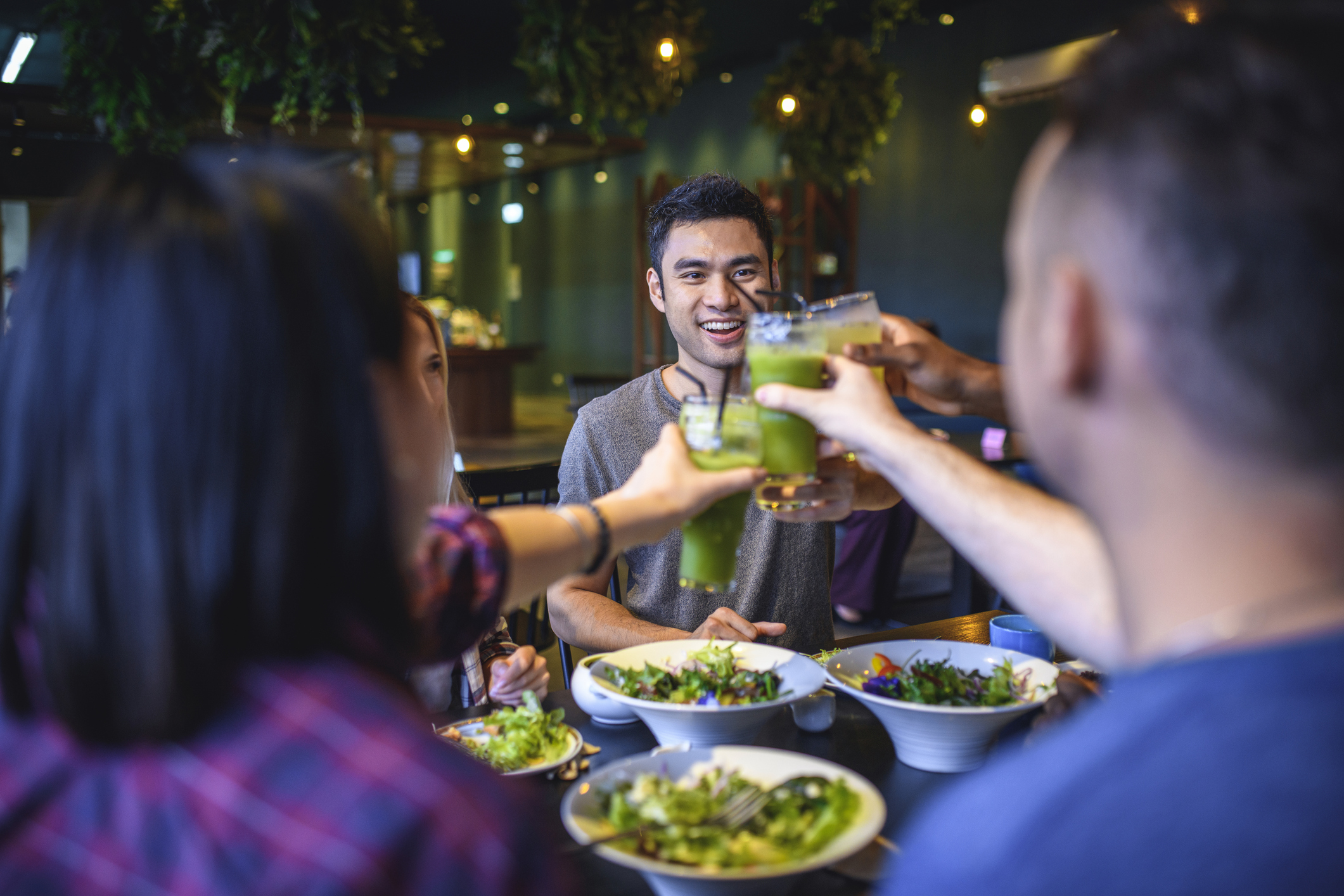 happy friends enjoying healthy dinner