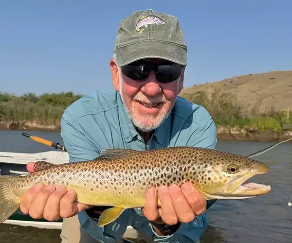 									Bozeman fly fishing trip brown trout and happy angler in july 2026
															