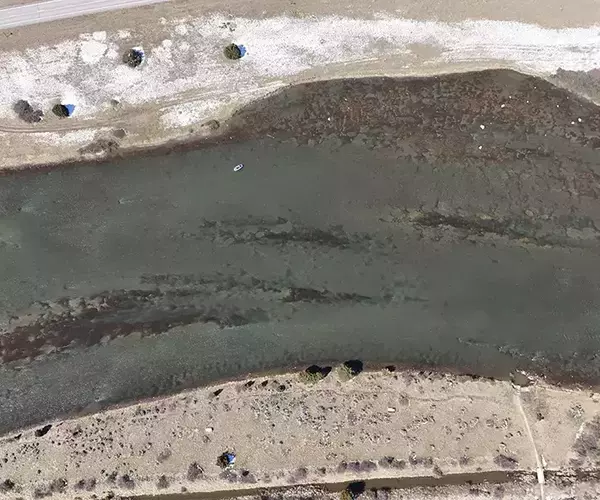 									Drone shot of anglers fly fishing montana on lower madison river
															