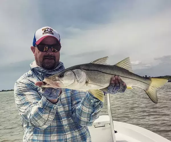 									Belize fly fsihing at el pescador lodge snook in hand
															