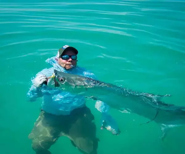 									Belize fly fsihing at el pescador lodge swimming with a tarpon
															