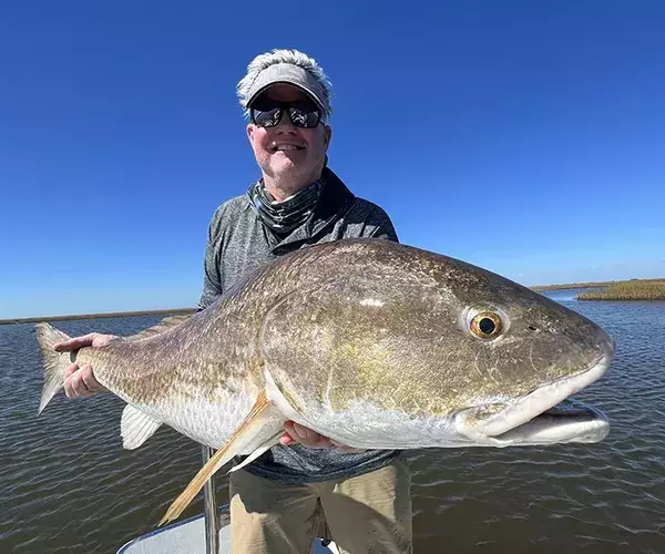 									Cocodrie louisiana redfish fly fishing beattie with a bull redfish
															
