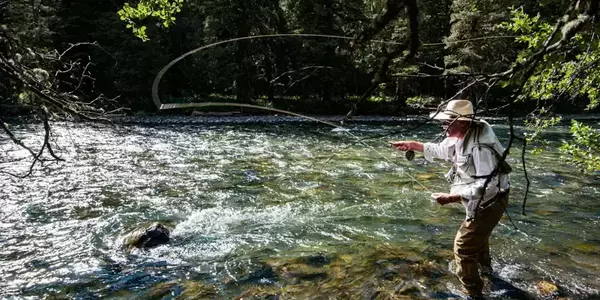 An angler fishes the Gallatin River in the canyon on his Montana fly fishing vacation