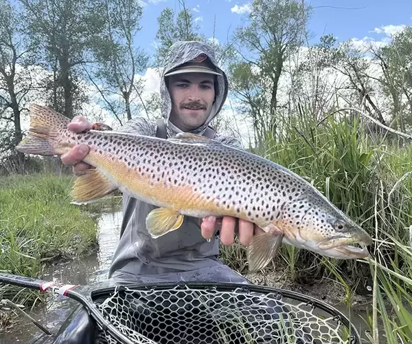 Bozeman fly fishing guide colman breckbill with a montana bronw trout