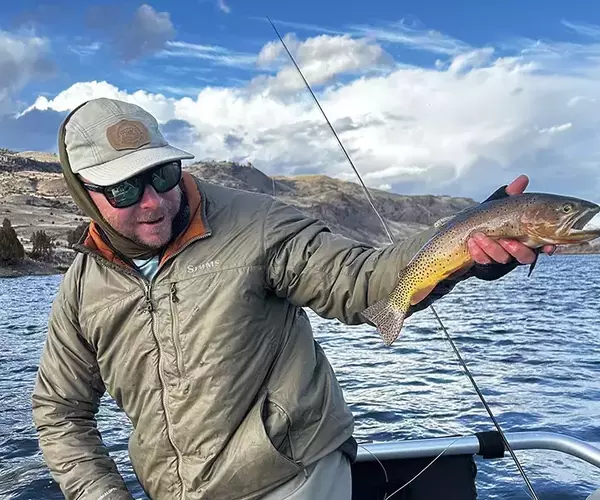 Bozeman fly fishing guide sam hunter with a wild cutthroat trout