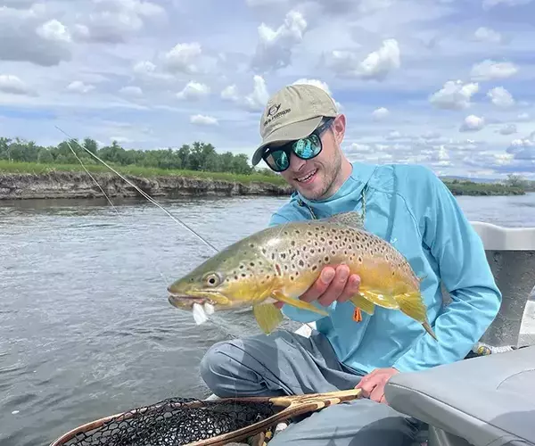 Bozeman mt fly fishing outfitter alex swank with a brown trout