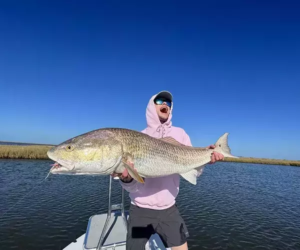 Bozeman mt fly fishing outfitter team alex swank with a louisiana redfish