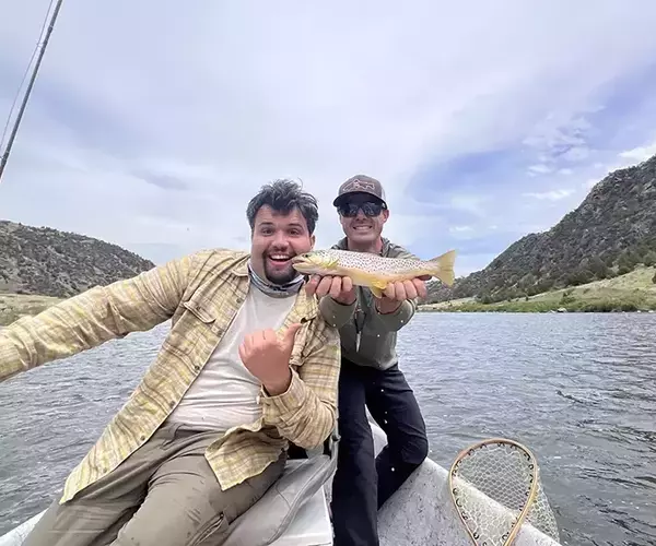 Bozeman fly fishing guide keeny wilson and a brown trout with guest