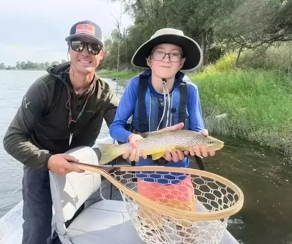 Bozeman montana fly fishing guide kenny wilson and happy guest