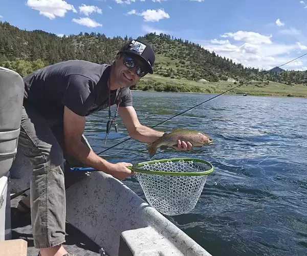 Montana fly fishing guide kenny wilson and a rainbow trout