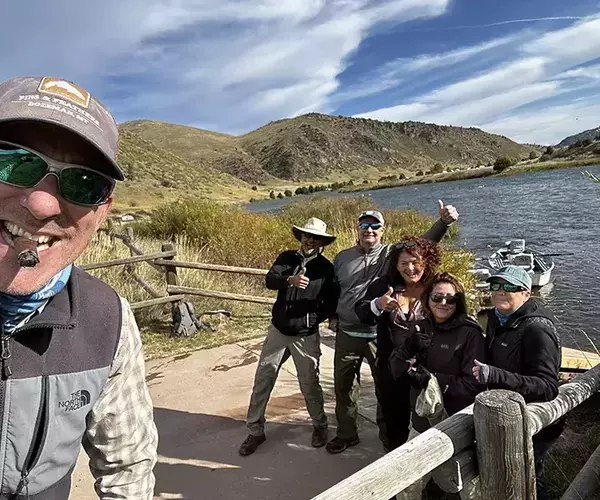 Happy anglers with fins and feathers guides