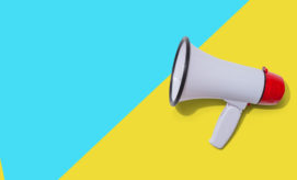A white megaphone with a red end rests motionless on a vibrant, diagonally split background of blue and yellow.