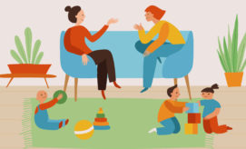 Adults converse on a blue sofa while children play with toys, like blocks and a ball, on a green rug. Potted plants decorate the room, enhancing a cozy atmosphere.