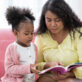 Early learning professional and preschool child reading together