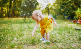 toddler playing and learning outdoors as climate change is ongoing