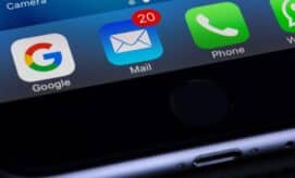 A smartphone screen displays app icons: Google, Mail with a red notification bubble showing "20," and Phone, against a black casing background.