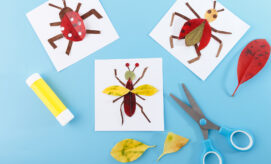 Colorful bug-themed art projects made with leaves on a blue background with scissors and glue.