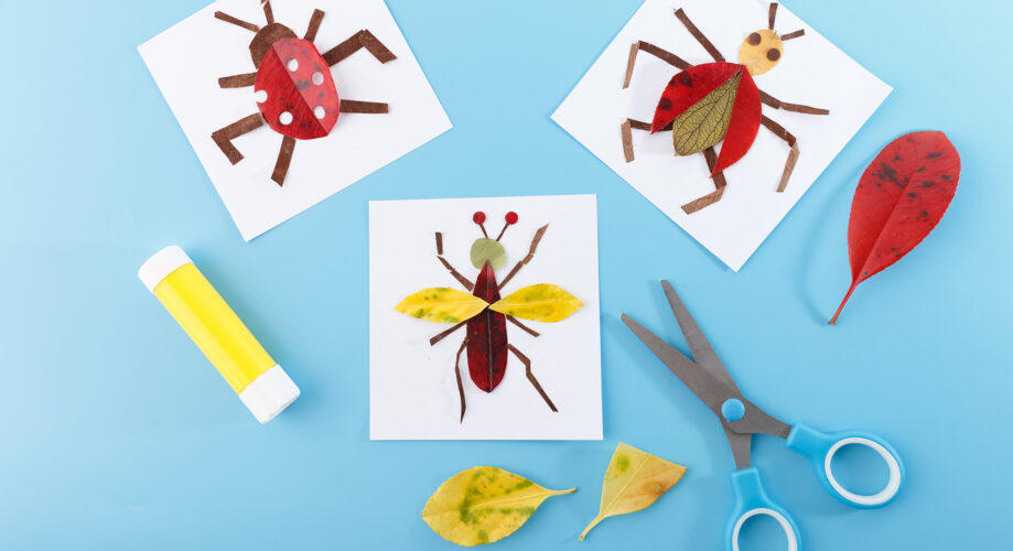 Colorful bug-themed art projects made with leaves on a blue background with scissors and glue.