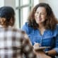 An early learning center educator and director sit together at a meeting to provide supervision and support.