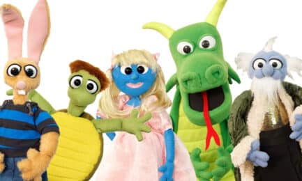 A group of puppet characters, including a princess and a dragon.
