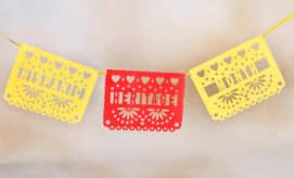 Colorful hanging paper flags in yellow and red that read, “Hispanic Heritage Month.”