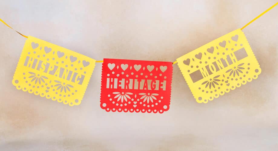 Colorful hanging paper flags in yellow and red that read, “Hispanic Heritage Month.”