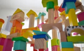 Colorful wooden blocks are stacked in an early learning classroom.