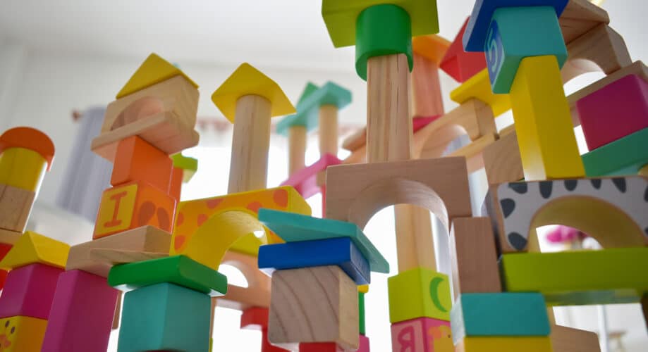 Colorful wooden blocks are stacked in an early learning classroom.